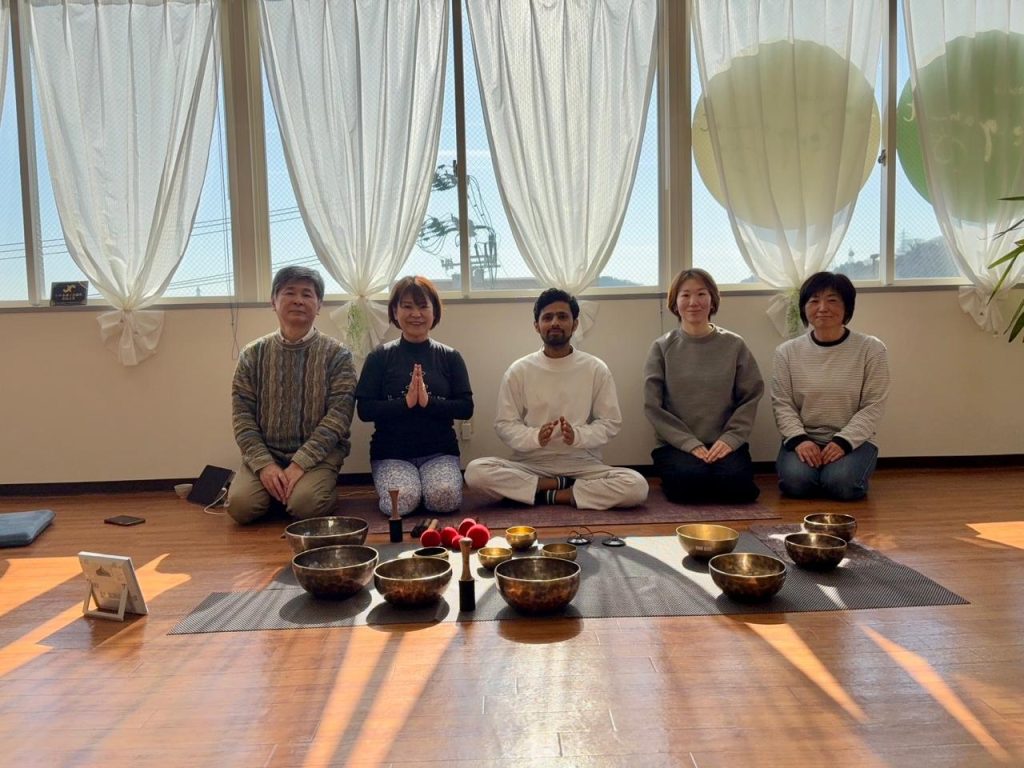 **Image Title:** 5 Days Sound Healing Retreat in Pokhara – Unmani Yoga Retreat **Alt Text:** Teacher sitting with a student in the yoga hall after a singing bowl sound healing session during the 5 Days Sound Healing Retreat in Pokhara at Unmani Yoga Retreat.