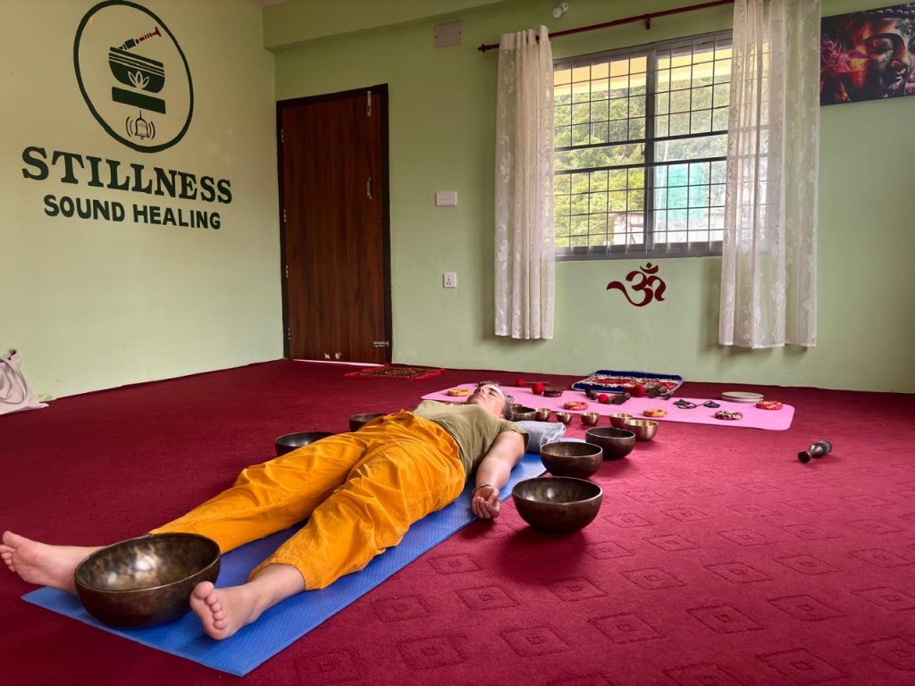 Woman experiencing a private Himalayan sound healing session with singing bowls in Pokhara, Nepal